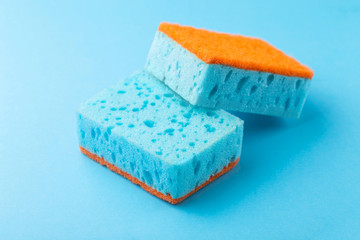 Sponges for dishwashing. Kitchen equipment. Blue background