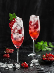 Fresh currant cocktail. Fresh summer cocktail with red currant and ice cubes. Glass of red currant mojito