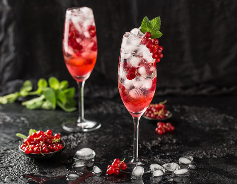 Fresh currant cocktail. Fresh summer cocktail with red currant and ice cubes. Glass of red currant mojito