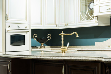interior of modern kitchen in baroque style with tap and oven