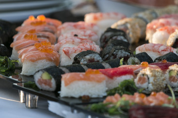 Various sets of sushi on table