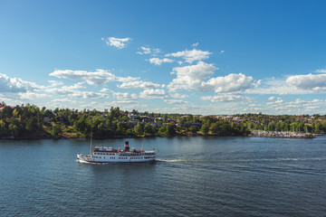 Obraz premium 10 July 2018 Stockholm, Sweden: Steamship full of tourists. Popular means to get around. Beautiful views of the Swedish islands on a sunny day.