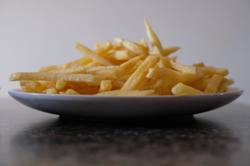 Fries on plate on counter