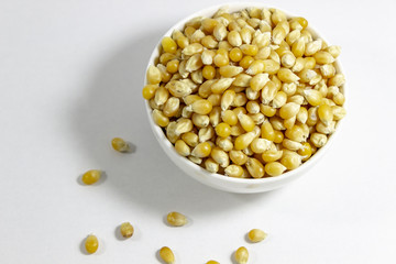 Close-up shoot of corn seeds in white small cup with natural concept