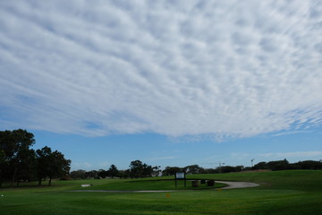 Fototapeta na wymiar Scattered Clouds on the golf course