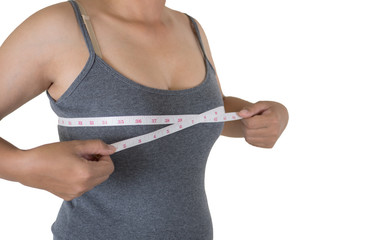 Young woman measuring chest using the tape measure.