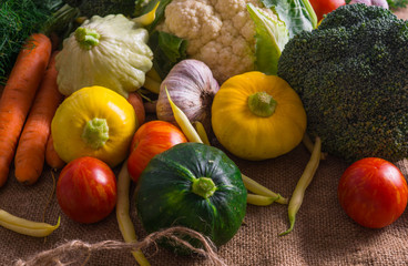 Different vegetables, small patissons, along with other vegetables, cauliflower, broccoli, garlic, cucumbers grown on an eco-farm