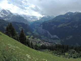 Panorama with valley and snow caps on mountain peaks