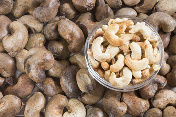 Natural and roasted cashew nut on wooden background - Anacardium occidentale