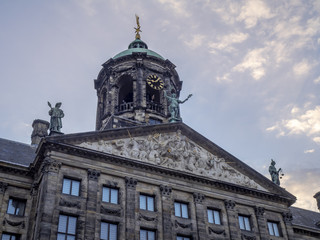 Detail of the Royal Palace at Dam square at dusk in Amsterdam. Dam square has become a very popular tourist destination.