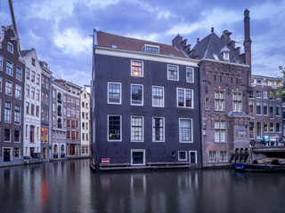 Traditional Dutch architecture on an Amsterdam canal at night. 