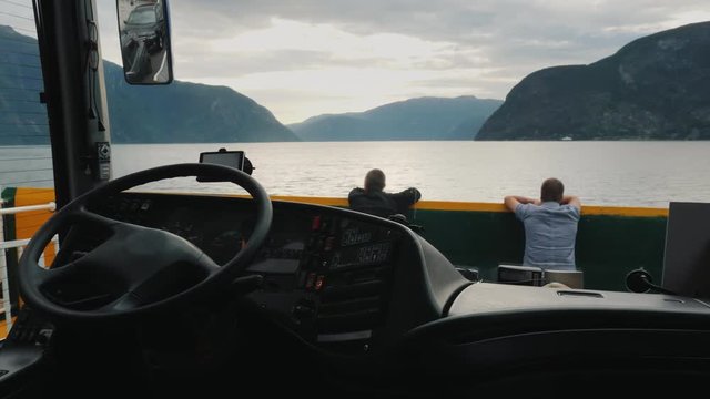 View from the bus that floats by ferry across the fjord. Two drivers are resting ahead
