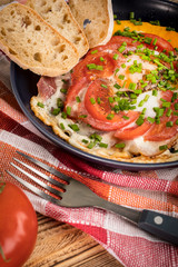 Homemade breakfast fried egg with tomato.