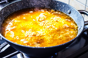Preparation of pilaf with lamb in frying pan