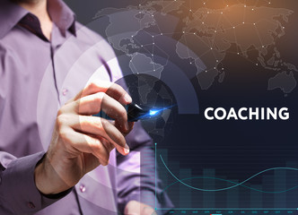 The concept of business, technology, the Internet and the network. A young entrepreneur working on a virtual screen of the future and sees the inscription: coaching