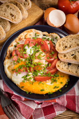 Homemade breakfast fried egg with tomato.
