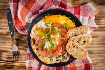 Homemade breakfast fried egg with tomato.