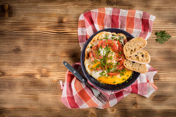 Homemade breakfast fried egg with tomato.