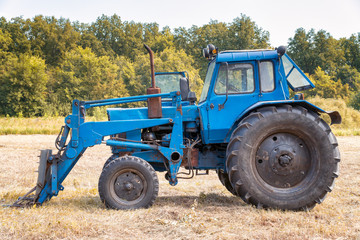 Obraz premium Tractor for working in the field and mowing grass