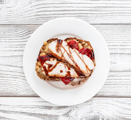 Breakfast sandwich with ham, pepper, cheese on plate on wooden background.  Healthy snack and appetizer top view, flat lay