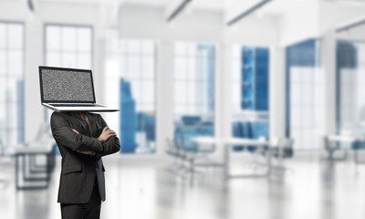 Businessman with laptop instead of head.