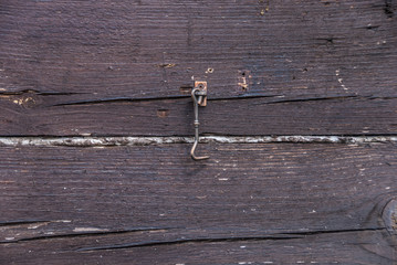 fragment of a wooden wall with a door hook. texture