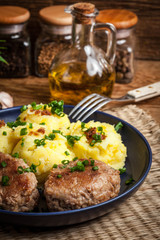 Meatballs served with boiled potatoes.