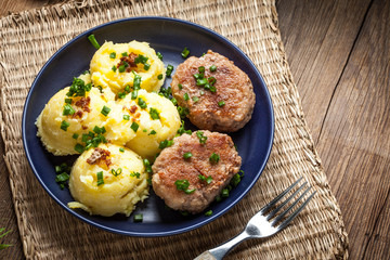 Meatballs served with boiled potatoes.