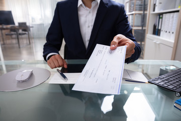 Businessman Giving Cheque