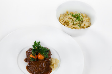 Goulash and spelled on a white plate.