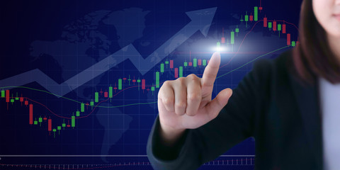 Business woman with financial symbols coming from hand .Hand holding on trading forex data information displayed on a stock exchange interface - Finance concept