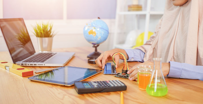 STEM education concept. man coding a meta program it on the computer.electronic board that can be programmed.technology,Mathematics. science. engineering.