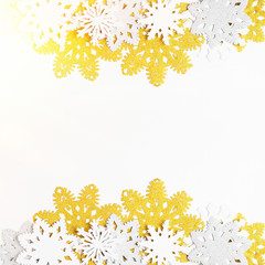 Golden, silver and white paper snowflakes on white background. New year, christmas concept. Text space