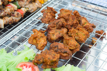Fried fish-paste balls on metal grille,Thai food.