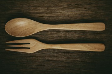 wood spoon and fork on old wooden desk. - vintage style.