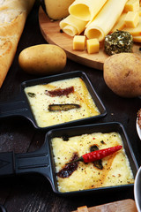 Delicious traditional Swiss melted raclette cheese on diced boiled or baked potato.