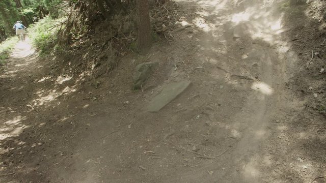 mountain biker rides through a curve, top shot