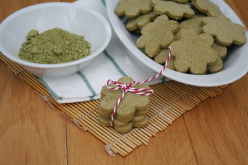 Homemade Green Matcha tea cookies in shape of flower on wooden table