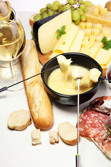 Gourmet Swiss fondue dinner on a winter evening with assorted cheese