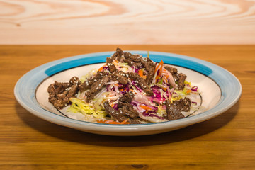 Delicious salad of fresh vegetables with spices on a plate. European Cafe