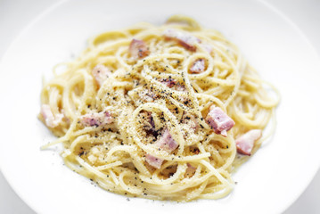 spaghetti pasta carbonara with bacon ham cream and kampot pepper