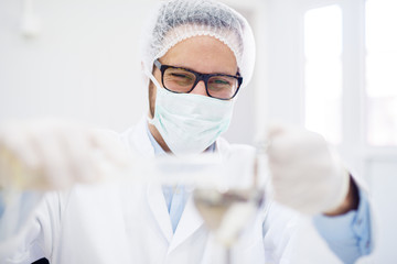 Hard working man in protective wear working in a laboratory.