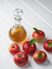 Ripe red apples and a bottle of vinegar concept homemade