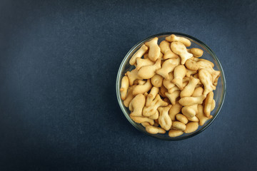 Delicious cookies in glass bowl on black background. View from above. Copy space