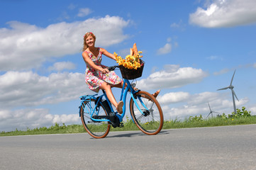 A carefree young woman is ecstatic about her new electric bicycle. She takes herself for a relaxing...