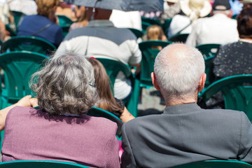 Elderly couple watching an outdoor show