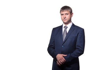 Young handsome businessman with beaming smile pointing with finger