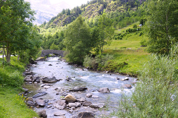 small old stone bridge located at the foot of the circus Gavarny in the Hautes-Pyrenees near the...