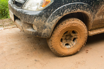 Closeup dirty Wheels in a countryside, Adventure background. Detail of dirty off-road car, Dirty offroad car side © 9kwan