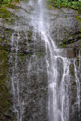 Fototapeta na wymiar Tall waterfall on the tropical island of Maui, Hawaii.